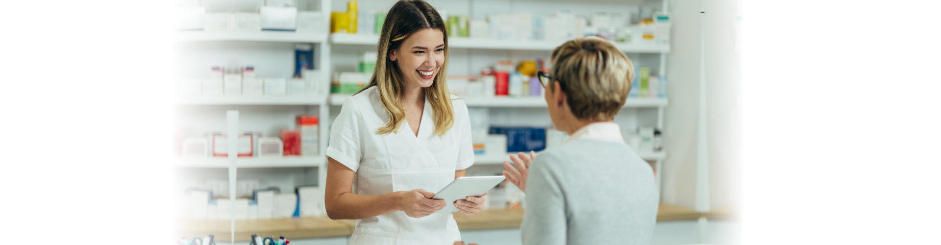 senior woman talking to a female pharmacist