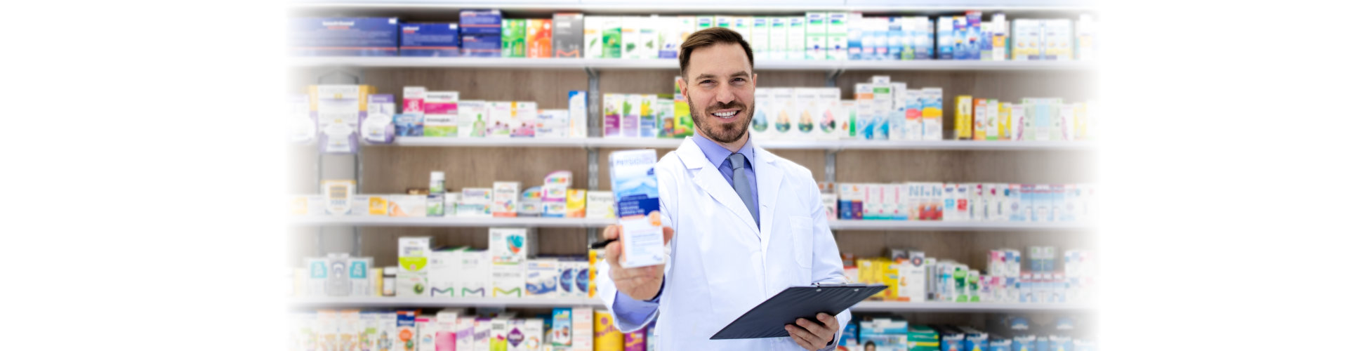 male pharmacist standing at the drugstore counter