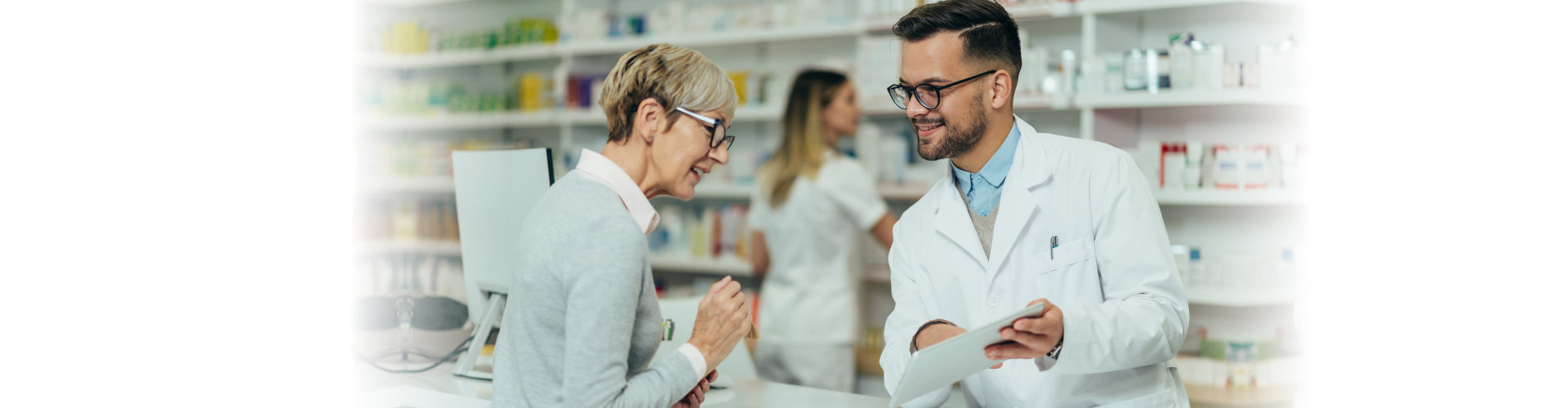 male pharmacist reminding medications to senior female customer