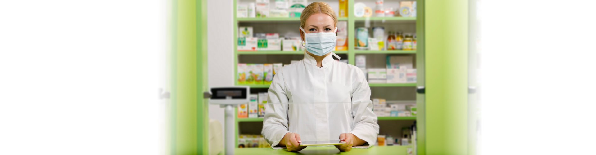 young female pharmacist with surgical mask