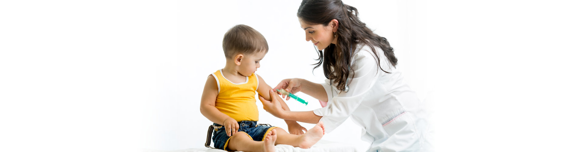 doctor injecting a vaccine to a child